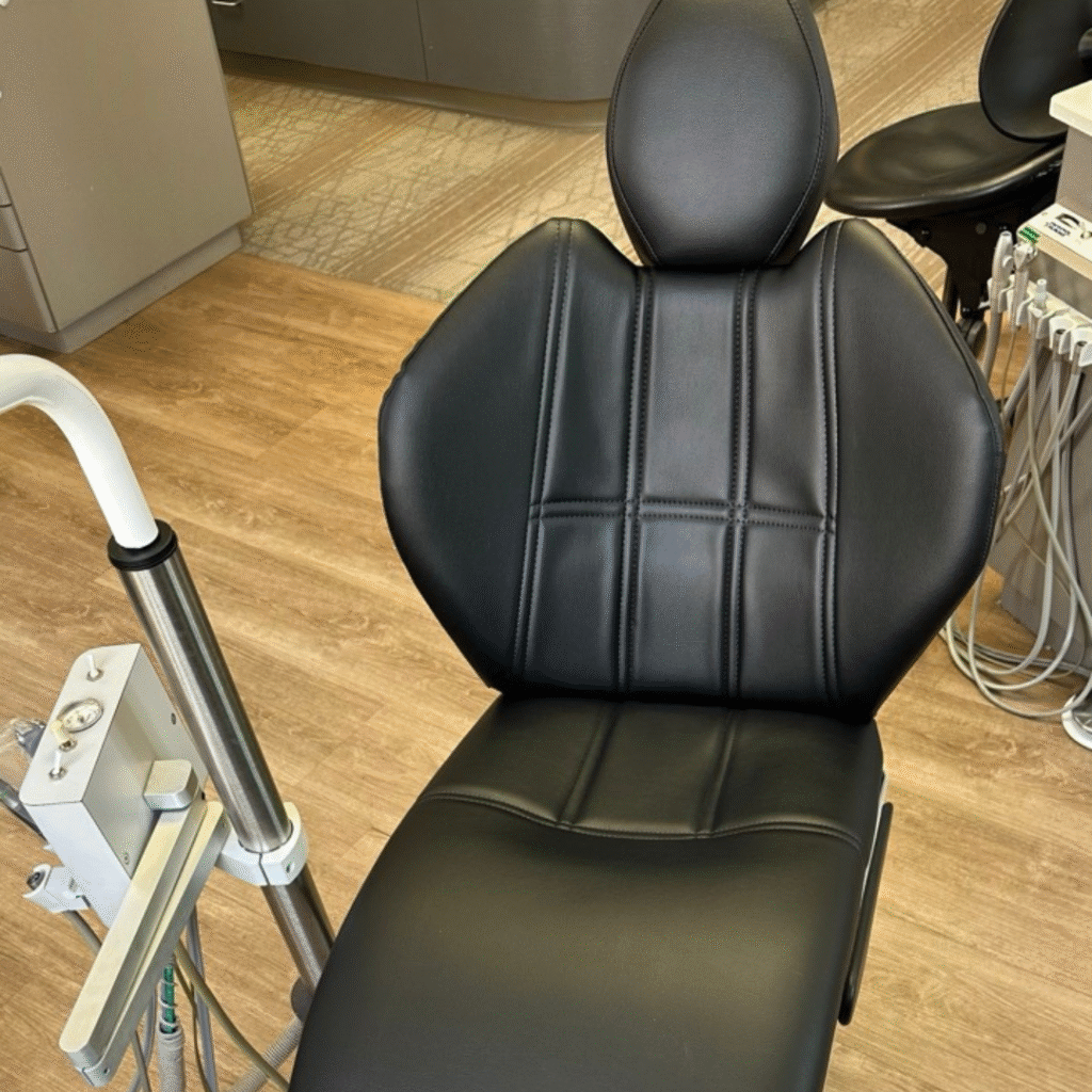 Black medical chair with new smooth upholstery after restoration
